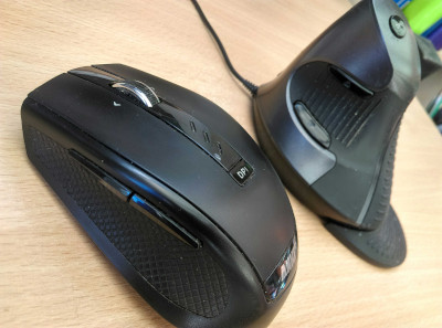 A photograph of two computer mice featuring back and forward navigation buttons